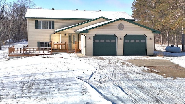 view of front facade with a garage and a wooden deck