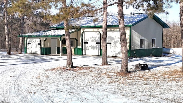 snow covered property with an outdoor structure