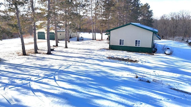 yard layered in snow with a garage