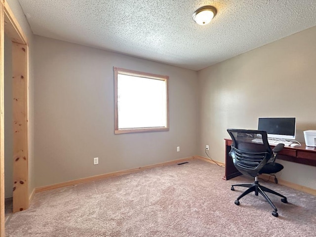 office area with carpet and a textured ceiling