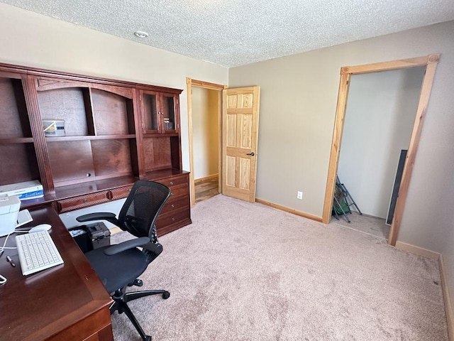 carpeted home office with a textured ceiling