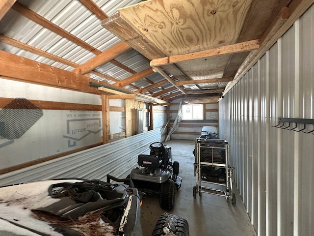 misc room with concrete flooring and vaulted ceiling