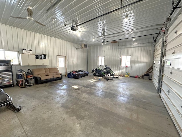garage with metal wall and a garage door opener