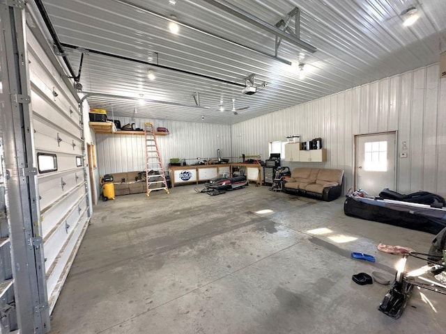 garage with metal wall and a garage door opener