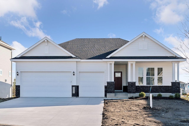 view of front of home featuring a porch and a garage