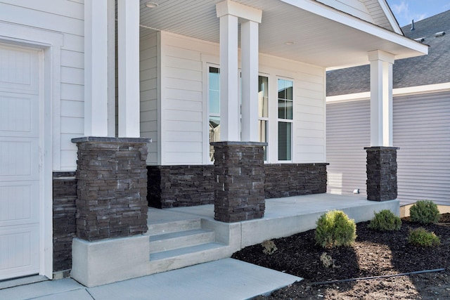 view of exterior entry with a porch