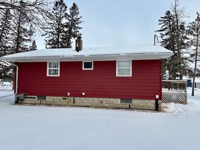 snow covered property featuring a deck