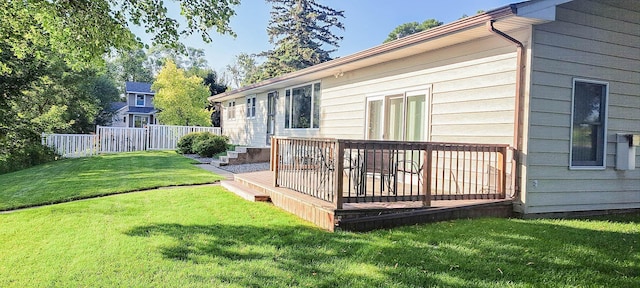 wooden deck featuring a yard