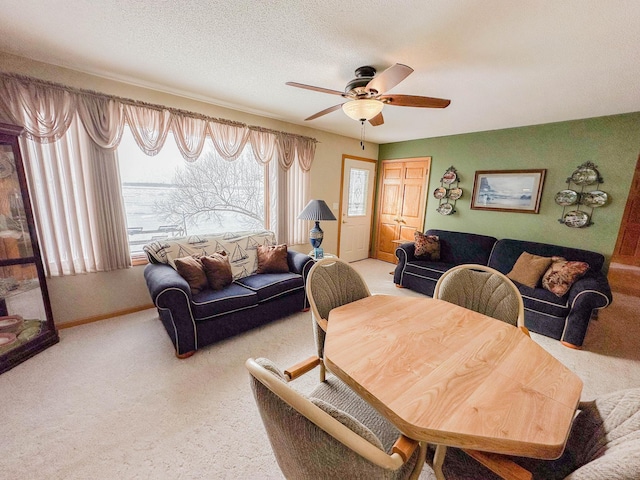 carpeted living room featuring ceiling fan and a textured ceiling