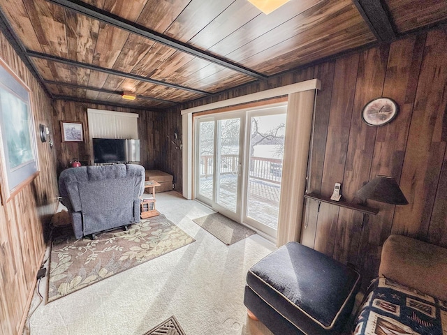 carpeted living room featuring wooden walls and wood ceiling