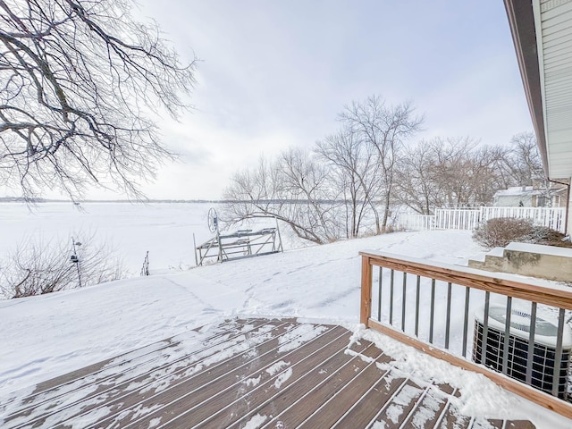 snow covered deck featuring cooling unit