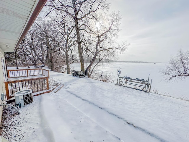 yard covered in snow featuring central AC unit