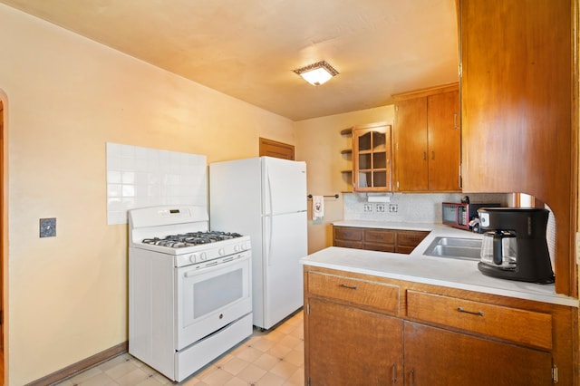 kitchen with backsplash, white appliances, and kitchen peninsula