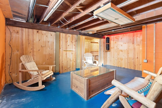 interior space featuring concrete floors and wood walls