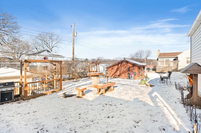 snowy yard with an outbuilding