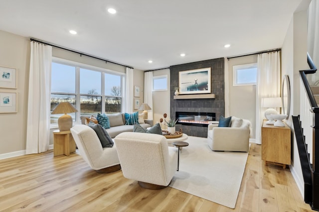 living room with light hardwood / wood-style flooring and a fireplace