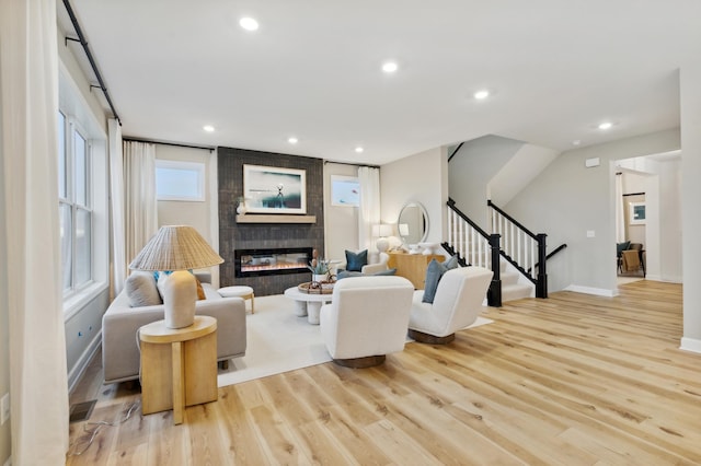 living room with a fireplace and light hardwood / wood-style floors