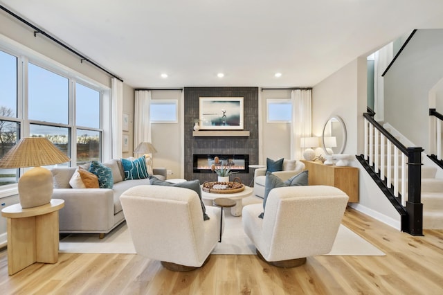 living room with light hardwood / wood-style floors and a fireplace