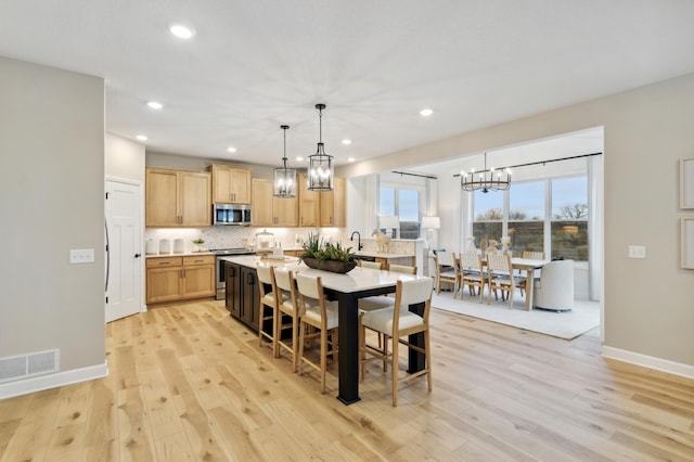 dining room featuring light hardwood / wood-style flooring and sink