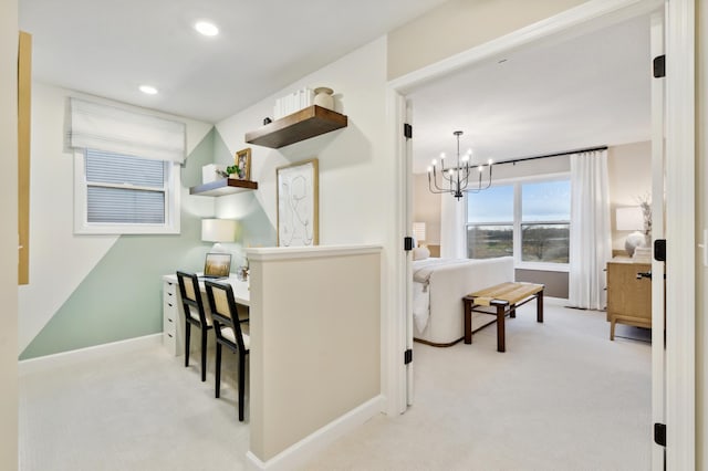 kitchen with hanging light fixtures, light colored carpet, and a notable chandelier