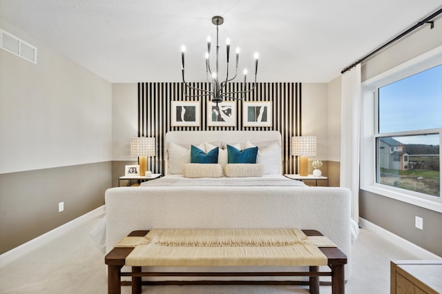 bedroom with light carpet and a chandelier