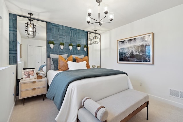 bedroom featuring a closet, light carpet, and a notable chandelier