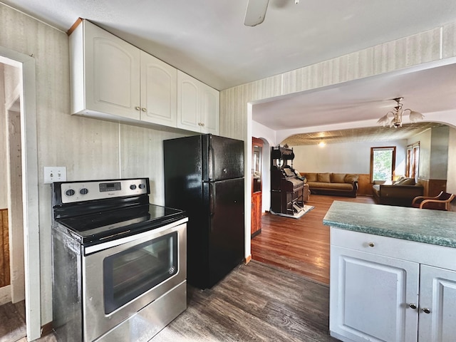 kitchen with stainless steel range with electric cooktop, white cabinetry, black fridge, ceiling fan, and dark hardwood / wood-style flooring