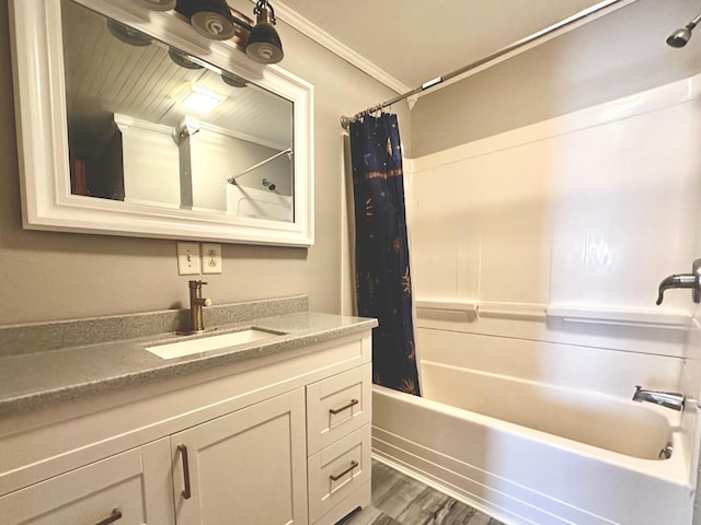 bathroom featuring hardwood / wood-style flooring, shower / bath combo with shower curtain, crown molding, and vanity