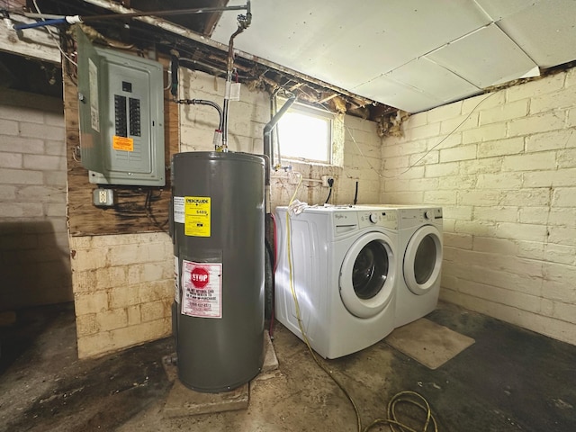 laundry area with water heater, washing machine and clothes dryer, and electric panel