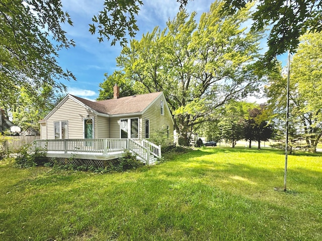 exterior space featuring a lawn and a wooden deck