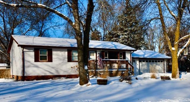 ranch-style home featuring covered porch and a garage