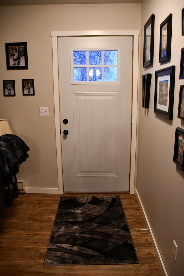 doorway with dark hardwood / wood-style floors