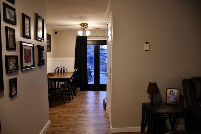 hall featuring dark hardwood / wood-style flooring and a textured ceiling