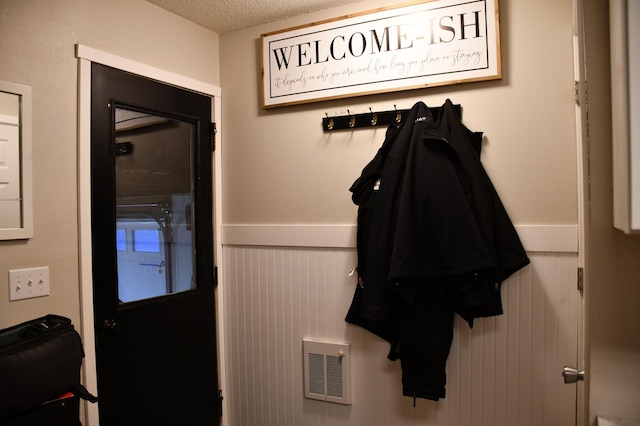 mudroom featuring a textured ceiling