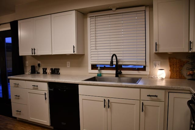 kitchen with white cabinets, black dishwasher, and sink