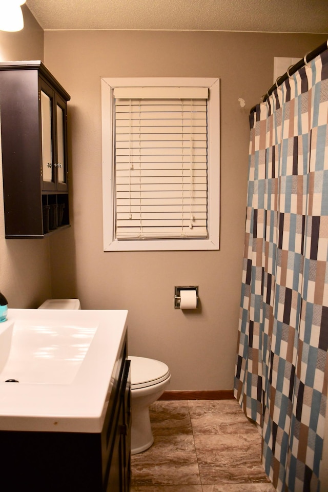 bathroom with vanity, a shower with curtain, a textured ceiling, and toilet