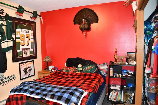 bedroom featuring a textured ceiling and a baseboard radiator