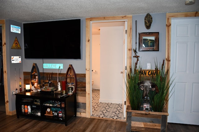 living room with dark hardwood / wood-style flooring and a textured ceiling