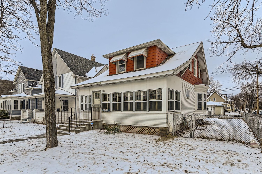 view of snow covered back of property