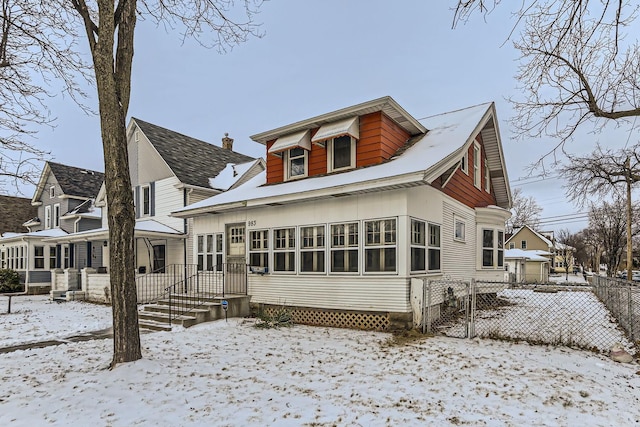 view of snow covered back of property