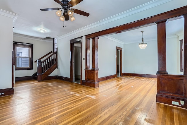 living room featuring ceiling fan with notable chandelier, ornamental molding, hardwood / wood-style floors, and ornate columns