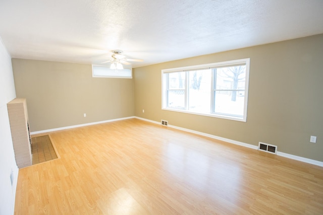 spare room with wood-type flooring, a textured ceiling, and ceiling fan