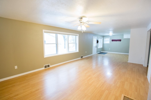 unfurnished room featuring ceiling fan, light hardwood / wood-style flooring, and a textured ceiling