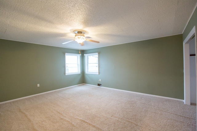 unfurnished bedroom featuring ceiling fan, carpet floors, and a textured ceiling