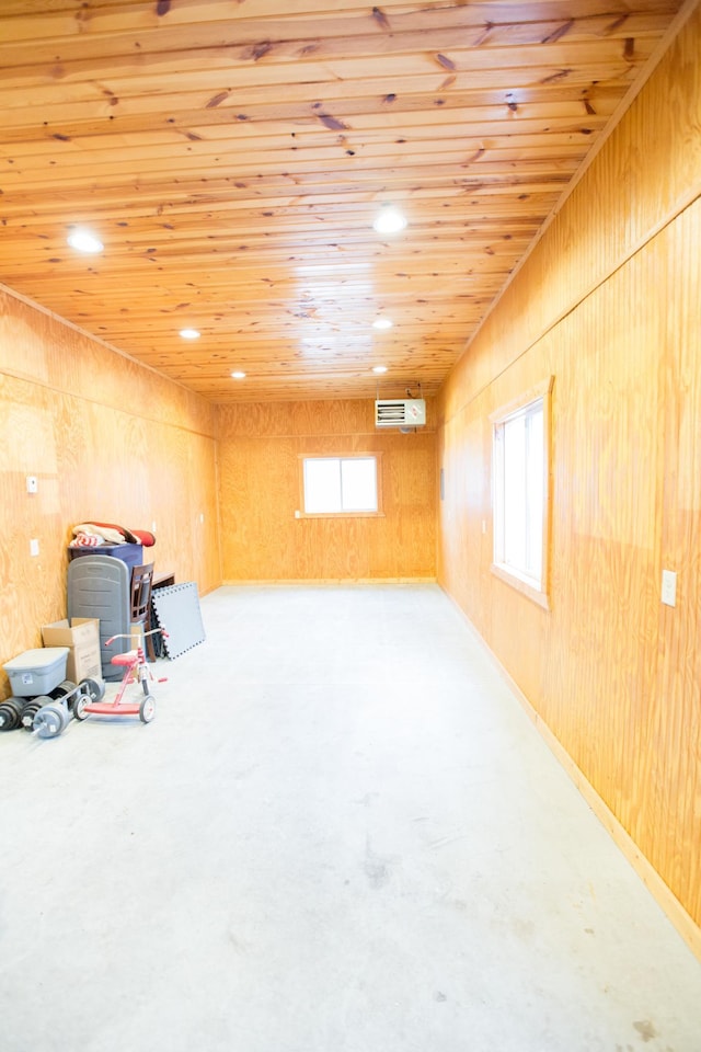 basement featuring an AC wall unit, wooden walls, and wooden ceiling