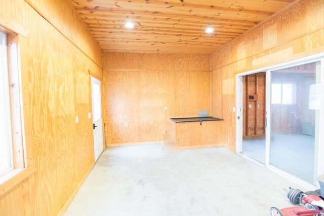 empty room with wood walls and wood ceiling