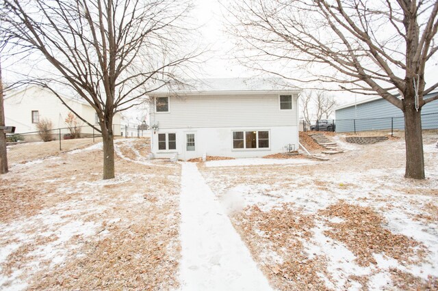 view of snow covered rear of property