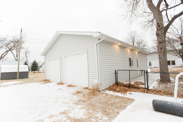 exterior space featuring a garage, an outbuilding, and sink