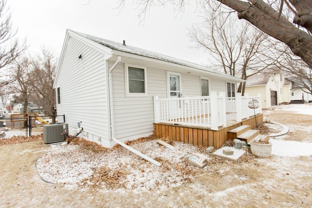 exterior space with a wooden deck and cooling unit