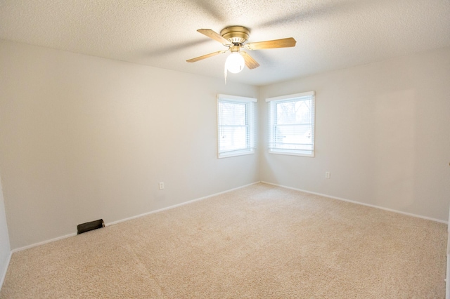 707 Haarfager Ave N, Canby, MN 56220 - unfurnished room featuring light colored carpet, ceiling fan, a textured ceiling, and baseboards